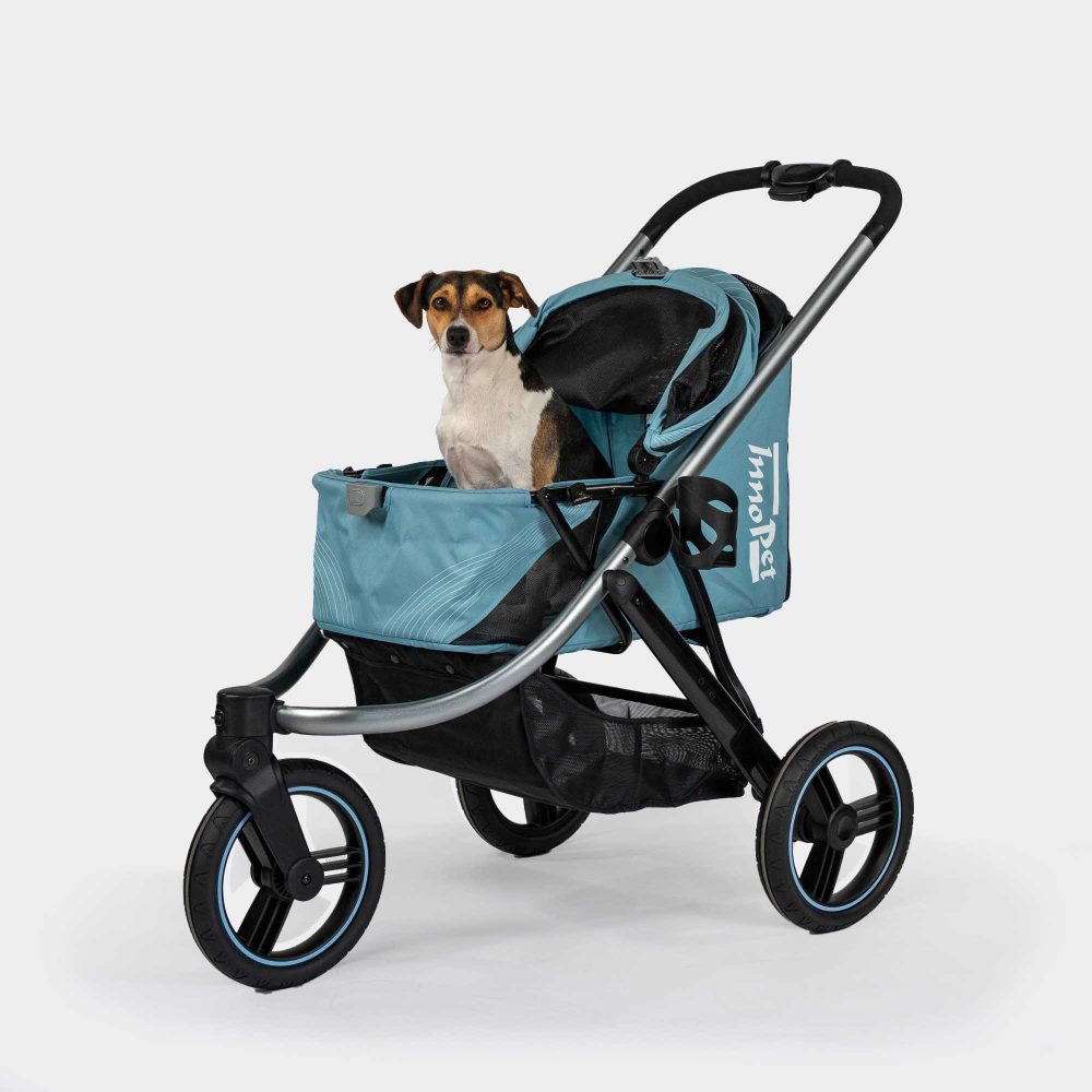 Small dog sitting inside the InnoPet Premium Comfort pet buggy in Light Blue with the canopy folded back.